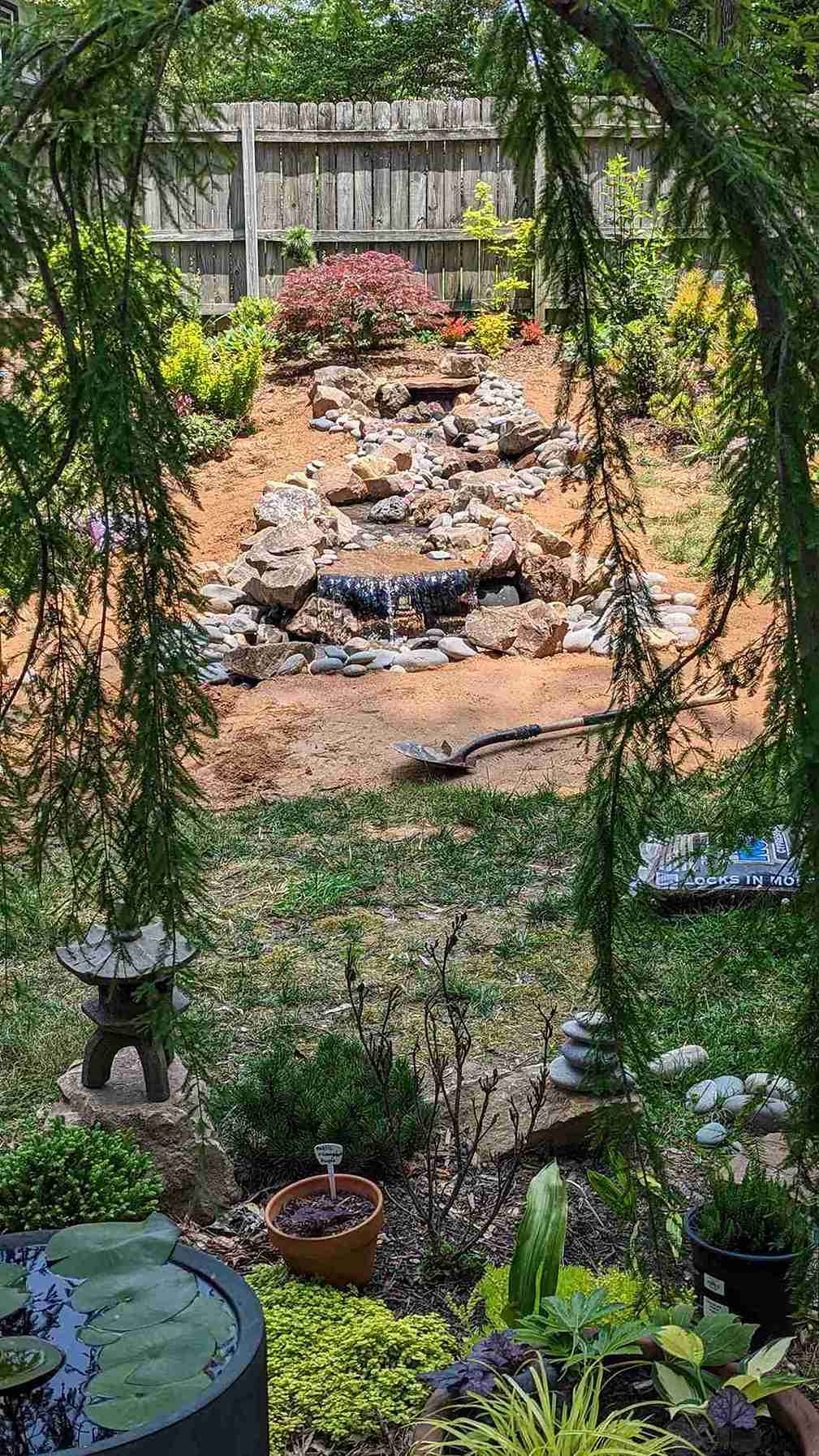 Backyard water feature with a natural stone waterfall and pond